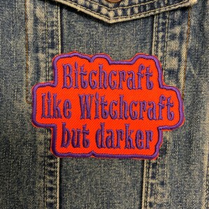 May include: Orange and purple embroidered patch with the text "Bitchcraft like Witchcraft but darker".