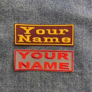 May include: Two embroidered patches with the text "Your Name" in different colours and fonts. The top patch is maroon with yellow lettering. The bottom patch is grey with red lettering.