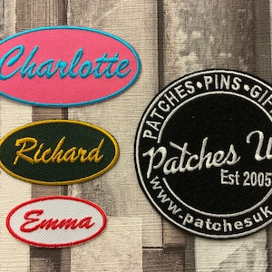 May include: Four embroidered patches, two oval shaped with names "Charlotte", "Richard", and "Emma" in cursive script, one round patch with the text "Patches UK Est 2005 www.patchesuk.co.uk" in white cursive script on a black background.
