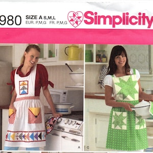 May include: Simplicity sewing pattern 2980 featuring aprons. The pattern includes sizes A, S, M, and L. The aprons have various designs, including a white apron with colorful pockets and a green apron with star-shaped accents. The Simplicity logo is visible.