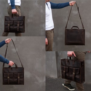 May include: A brown leather briefcase with two front pockets and a shoulder strap. The bag has a flap closure with buckles.
