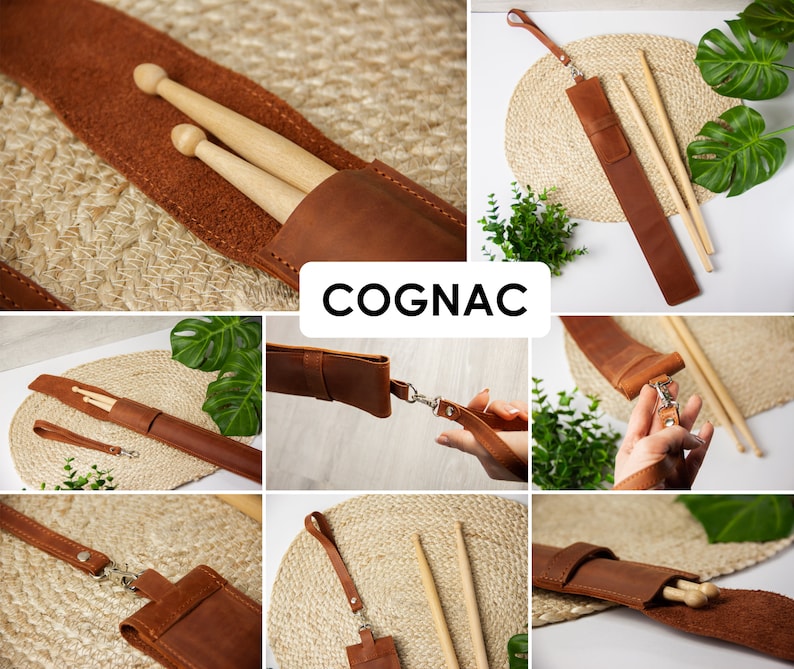 May include: A brown leather drumstick holder with a strap and a silver buckle. The holder is shown with two wooden drumsticks inside. The holder is labelled "COGNAC".