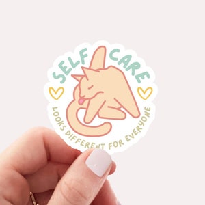 funny self care sticker with cat preening and words self care looks different for everyone