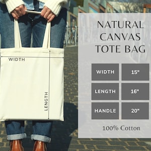 May include: A natural canvas tote bag with a white background and black text. The bag is 15 inches wide, 16 inches long, and has a 20 inch handle. It is made of 100% cotton.