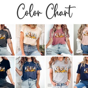 May include: A color chart displays various t-shirts in different colors, each featuring a Halloween-themed graphic of dogs, pumpkins, and bats. The available colors include dark gray, soft cream, heather mauve, and heather peach.