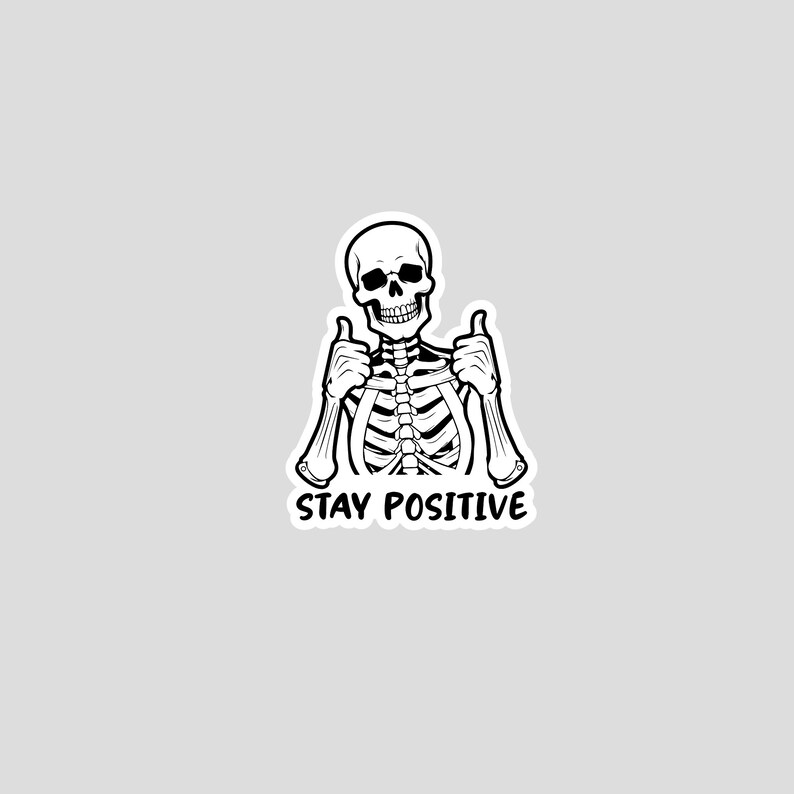 Sticker graphic of skeleton giving two thumbs up with the words stay positive