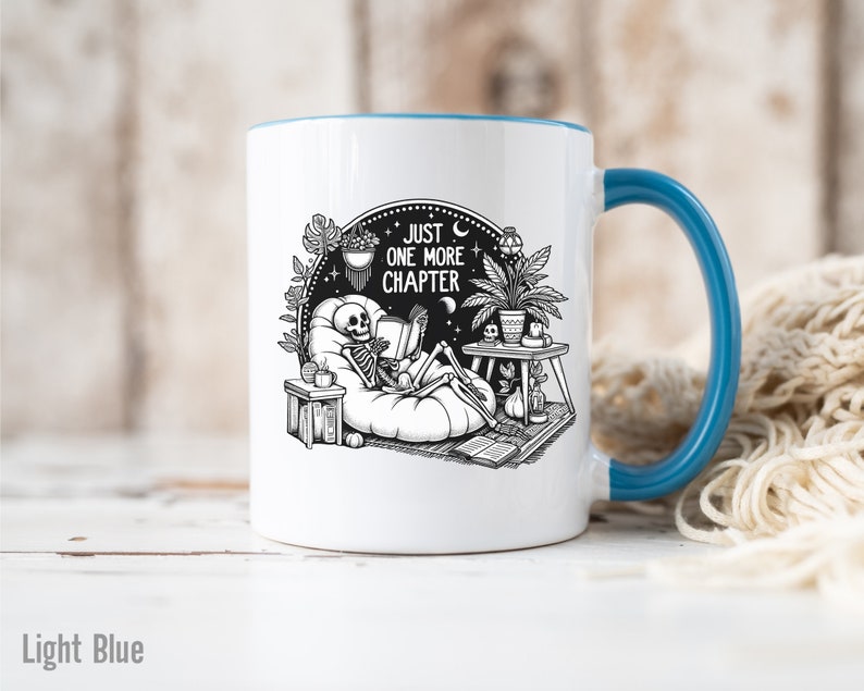 Light blue accent coffee mug with skeleton reading while lounging in a boho style room with the words Just One More Chapter