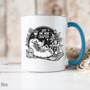 Light blue accent coffee mug with skeleton reading while lounging in a boho style room with the words Just One More Chapter