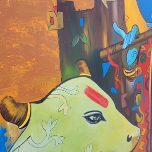 May include: A green cow with intricate floral patterns, a red mark on its forehead, and a black eye, is depicted in a colorful painting. The cow is standing next to a brown structure with a blue flute and a red and gold patterned fabric.