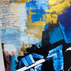 May include: Abstract painting of a person playing a flute. The painting is done in shades of blue, gold, and black. The person's hands are visible, holding the flute.