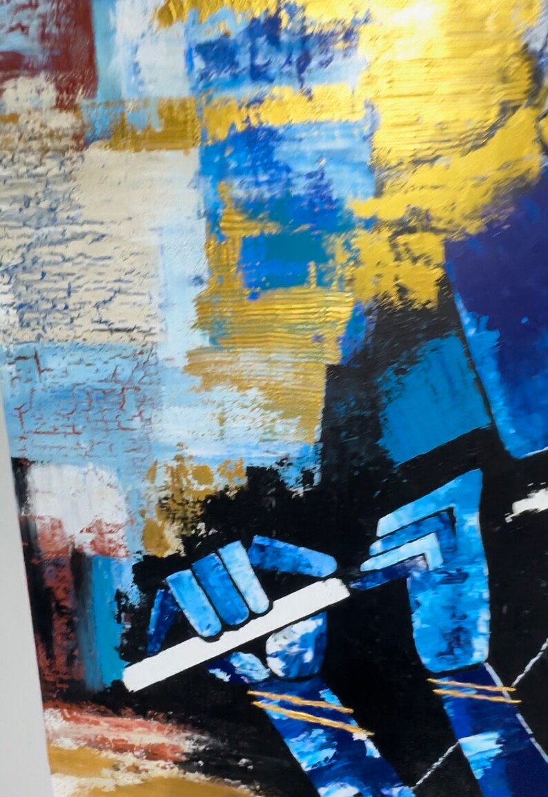 May include: Abstract painting of a person playing a flute. The painting is done in shades of blue, gold, and black. The person's hands are visible, holding the flute.