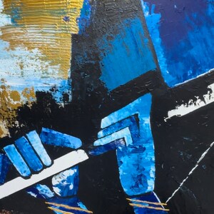 May include: Abstract painting depicting a person playing a flute. The artwork is painted in shades of blue, black, and gold. The person's hands are visible, holding the flute. The background is a mix of blue, black, and gold.