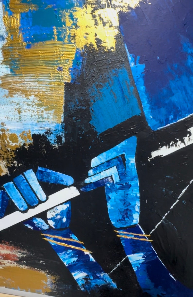 May include: Abstract painting depicting a person playing a flute. The artwork is painted in shades of blue, black, and gold. The person's hands are visible, holding the flute. The background is a mix of blue, black, and gold.