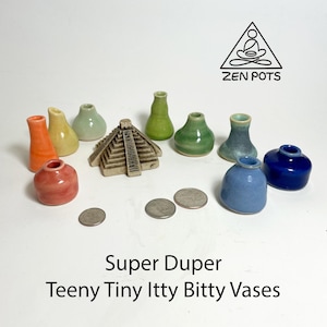 May include: A collection of small, colorful ceramic vases in various shapes and shades, including orange, yellow, green, blue, and red. A miniature pyramid and several coins are also present. The text "Super Duper Teeny Tiny Itty Bitty Vases" is displayed.