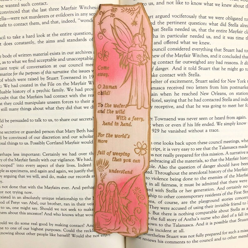 May include: A pink and gold bookmark with a fairy illustration and the text "Come away, O human child. To the waters and the wild with a faery, hand in hand. For the world's more full of weeping than you can understand."