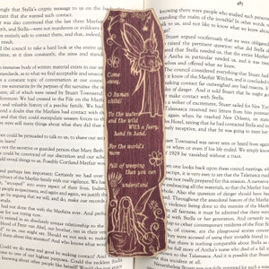 May include: A brown and tan bookmark with a fairy illustration. The fairy is holding a flower and has a quote that reads "Come away, O human child! To the waters and the wild. With a faery, hand in hand. For the world's more full of weeping than you can understand."