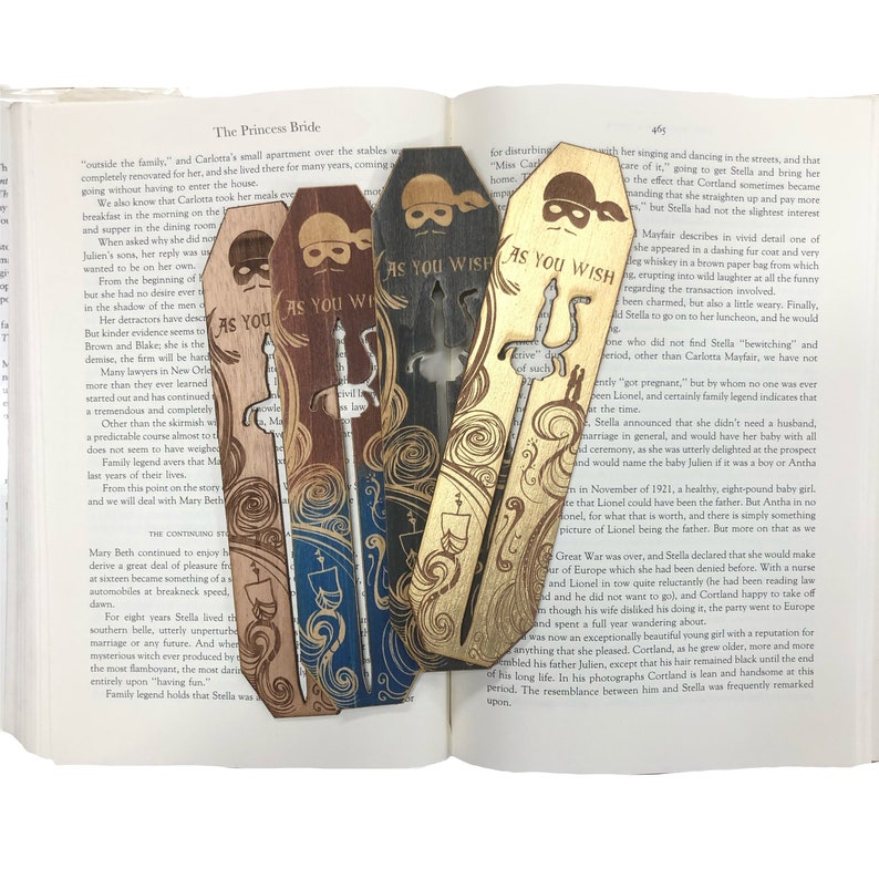 May include: Four wooden bookmarks with a pirate design. Each bookmark features a different color and design. The text "As You Wish" is printed on each bookmark.