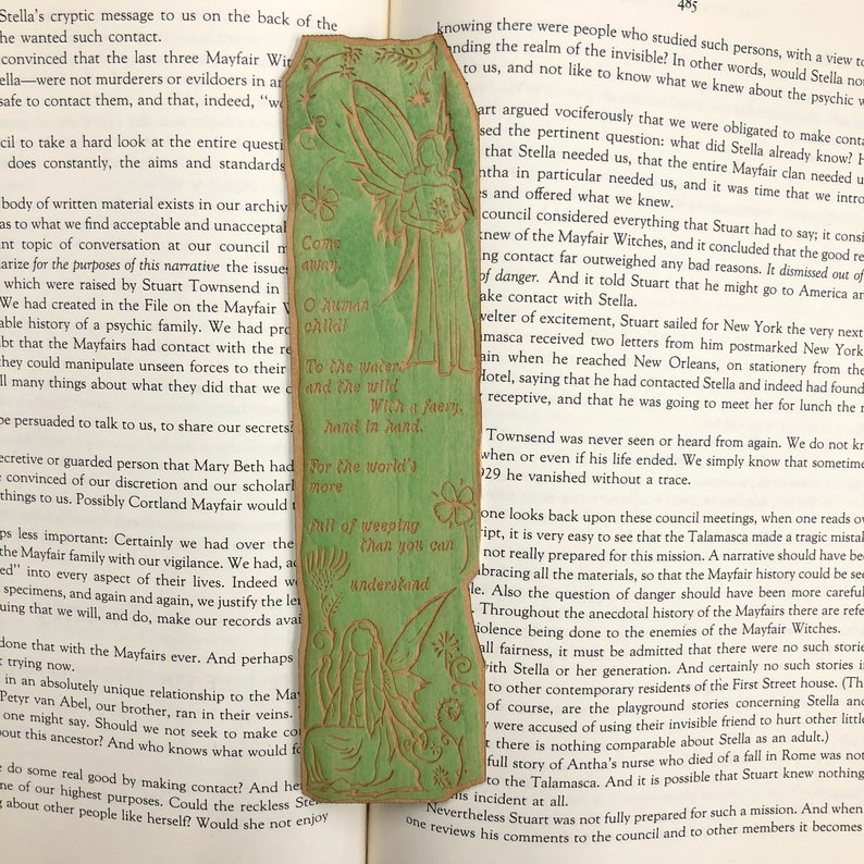 May include: A green bookmark with a fairy illustration and a quote: "Come away, O human child. To the waters and the wild. With a faery, hand in hand. For the world's more full of weeping than you can understand."