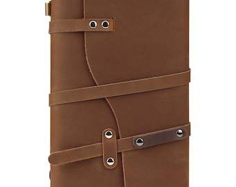 May include: A brown leather journal with a strap closure and metal accents. The journal has a rustic look and is perfect for writing or sketching.