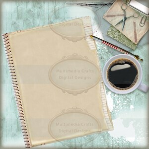 May include: A vintage-style notebook with a spiral binding, a cup of coffee, a pencil, and a pair of scissors on a blue and white textured background. The notebook has a blank page with the text "Multimedia Crafts Digital Designs" repeated three times.