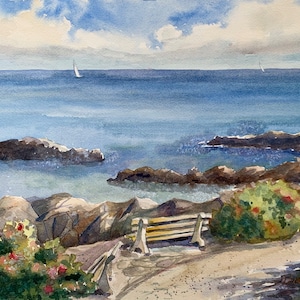 May include: A watercolor painting of a seascape with a wooden bench overlooking the ocean. The water is a light blue color and there are rocks in the foreground. There are two sailboats in the distance.