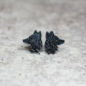 May include: A pair of black glitter wolf head stud earrings. The earrings are small and delicate, and they would make a great gift for any wolf lover.