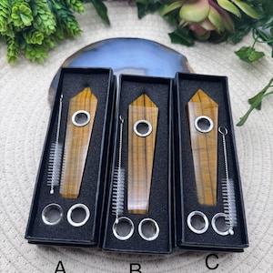May include: Three tiger's eye crystal pipes in black boxes with cleaning brushes. The pipes are labeled A, B, and C.