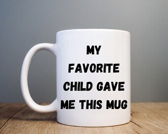 May include: White ceramic mug with black text that reads "My Favorite Child Gave Me This Mug".