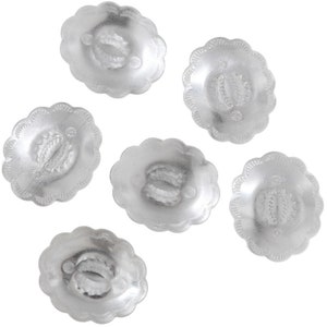 May include: Six silver-coloured metal buttons with a decorative design. The buttons have a scalloped edge and a raised design in the centre.