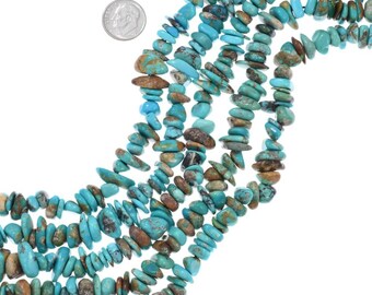 May include: A strand of turquoise beads, featuring a mix of blue and brown hues. The beads are irregular in shape and size, with some being more elongated than others. The beads are strung together on a clear thread, and the strand is long enough to be worn as a necklace or bracelet.