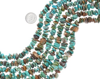 May include: A strand of turquoise beads, featuring a variety of shades of blue and green, with brown and black matrix. The beads are irregular in shape and size, and are strung on a clear cord. The beads are approximately 1/2 inch in diameter.