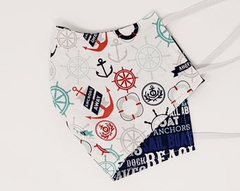 May include: Two white fabric face masks with adjustable elastic ear loops. One mask features a nautical theme with anchors, wheels, and rope. The other mask features a blue and white nautical themed print with the words "Sailboat, Beach, Ships, Sea, Anchors, Away".