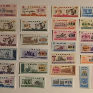 May include: A collection of vintage Chinese food ration coupons from the 1900s. The coupons are printed on paper and feature various designs, including images of buildings, trains, and people. The coupons are in various denominations, including 1, 2, 5, 10, and 100. The coupons are in various colors, including red, blue, green, and yellow.