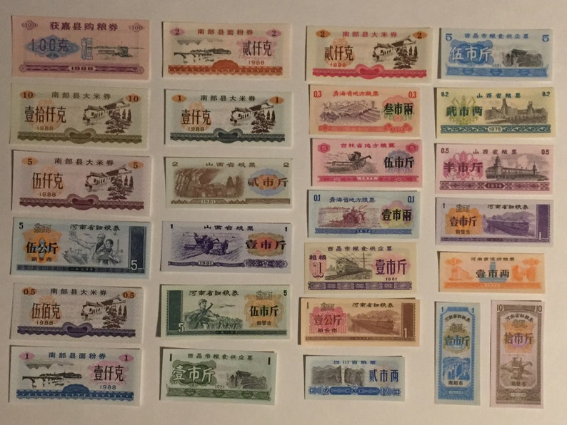 May include: A collection of vintage Chinese food ration coupons from the 1900s. The coupons are printed on paper and feature various designs, including images of buildings, trains, and people. The coupons are in various denominations, including 1, 2, 5, 10, and 100. The coupons are in various colors, including red, blue, green, and yellow.