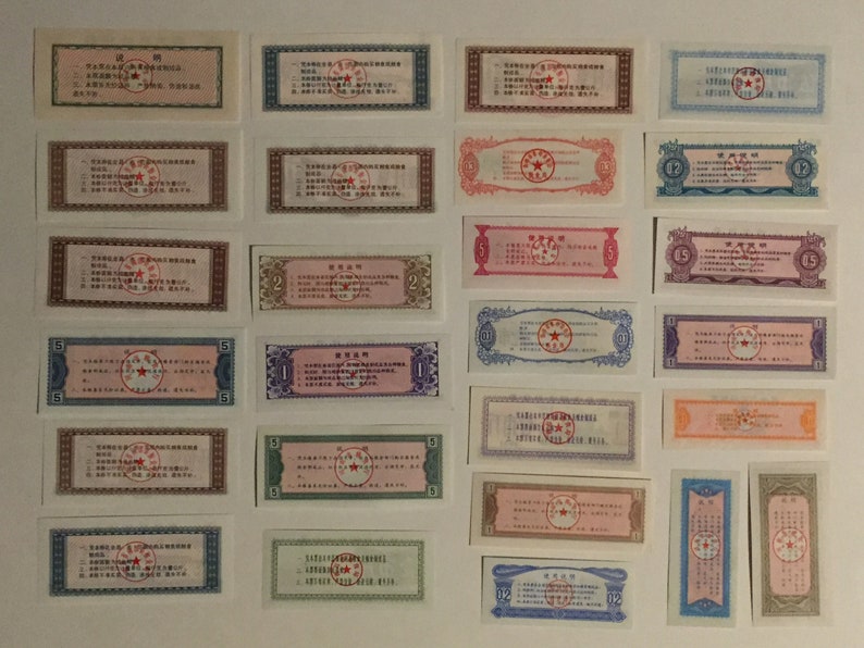 May include: A collection of vintage Chinese paper money featuring a red star and Chinese text. The denominations include 1, 2, 5, and 12.