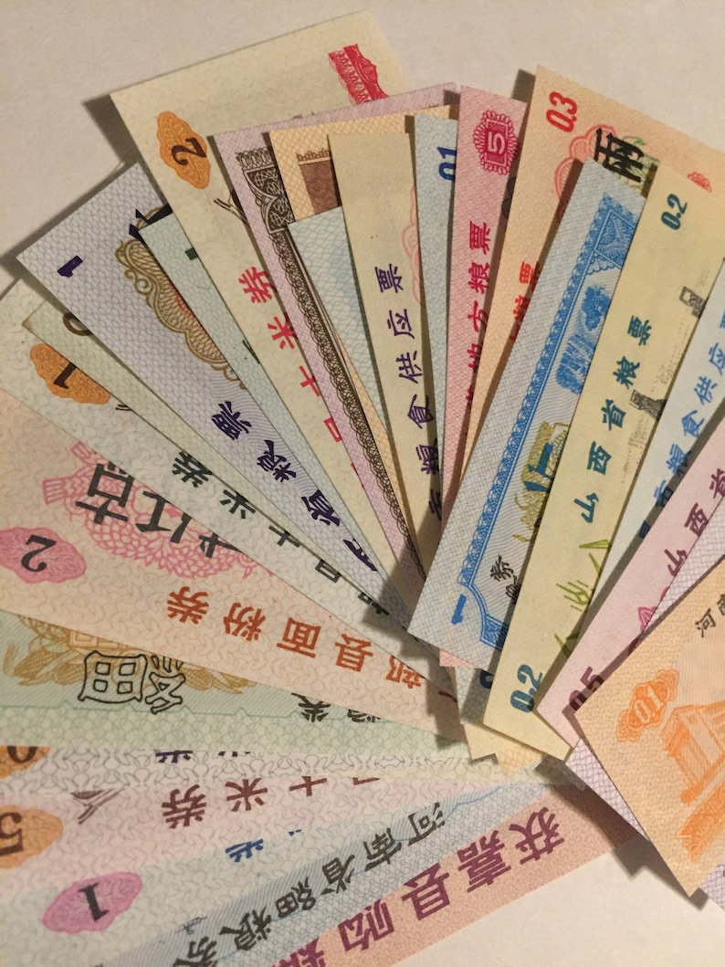 May include: A collection of vintage Chinese food ration coupons, featuring various colors and designs, with text in Chinese characters.