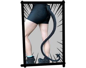 May include: A black tail with a pointed tip attached to a person's waist. The tail is made of soft, plush material and is about 60 cm long. The person is wearing black shorts and black boots.