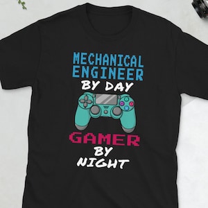 May include: Black t-shirt with a graphic design of a video game controller and the text "Mechanical Engineer by Day Gamer by Night".