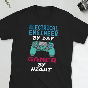 May include: Black t-shirt with a graphic design of a video game controller and the text "Electrical Engineer by Day Gamer by Night".