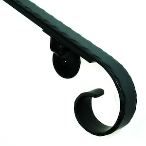 May include: Black metal handrail with a decorative scroll design. The handrail is mounted to a wall with a round bracket.
