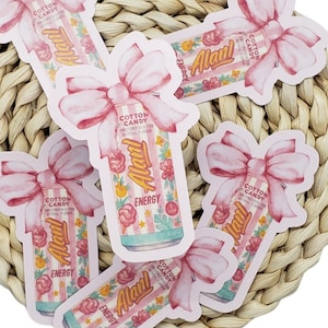 May include: A collection of stickers featuring a watercolor design of an Alani Energy drink can with a pink bow. The can is pink and white striped with floral accents and the words "Cotton Candy" and "Energy".