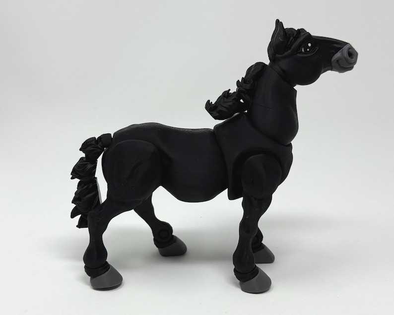 May include: A black articulated horse figurine with a detailed mane and tail. The horse has a sleek, modern design with gray hooves and joints. The figurine is posed in a standing position, showcasing its dynamic form.