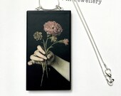 Hand holding flowers, Baroque art detail, sustainable wood pendant necklace with sterling silver chain.
