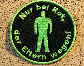 Patch "Only with red, because of the parents!" with Ampelmann (West) in bright green