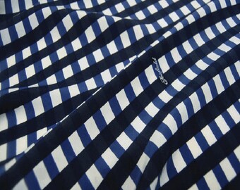 May include: Blue and white checkered fabric with a slight wrinkle in the center.