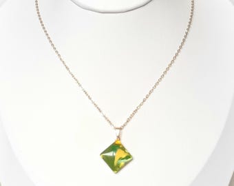 Designer pendant, colors vary in light, painted glass jewel on gold stainless steel in diamond shape