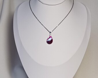 Purple and pearly designer pendant, changes in the light, painted glass jewel on silver stainless steel in the shape of a drop