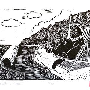 May include: Black and white linocut print of a cat relaxing on a beach chair, wearing a lei and holding a drink. The scene includes a beach, ocean waves, palm trees, and mountains. The print is signed and numbered.