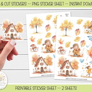 May include: A digital sticker sheet featuring watercolour illustrations of autumn themes including a cottage, trees with yellow leaves, mushrooms, a child with a dog, a bicycle, and umbrellas, with the text "HELLO FALL" printed on the sheets.