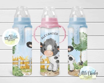May include: Three 8oz baby bottles with a cow design. The bottles are blue, pink, and blue. The middle bottle has the name "Alexander" on it. The bottles are for sublimation.